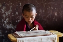 Very young novice monk studying in a monastery in Trashi Yangtse, Eastern Bhutan.