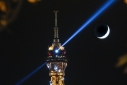 Eiffel Tower at night with crescent moon, Paris