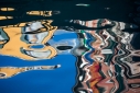 Abstract reflections of colorful buildings in a Venetian canal