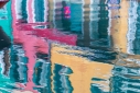 The colors of Burano's houses reflected in a canal, Veneto