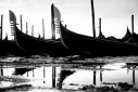 Gondolas reflected in the high tide flood water in the Bacino di San Marco, Venice