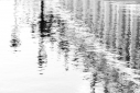 Impressions of lamp post and buildings reflected in rippled flood water in St. Mark's Square, Venice