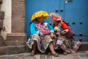 Peruvian woman and girl in traditional costume with lambs, Cusco, Peru