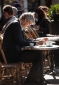 Man reading newspaper at outdoor cafe, Paris