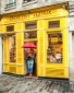 Woman with red umbrella at pastry shop in the Marais, Paris