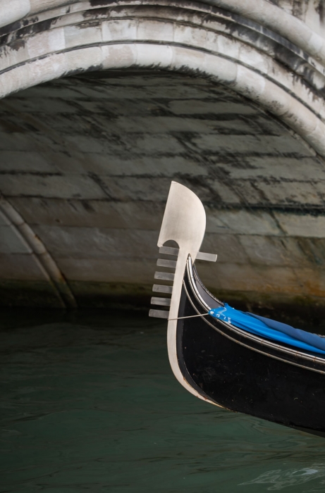 Gondola prow under bridge, Venice