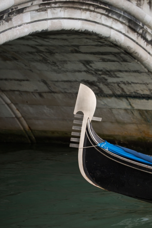 Gondola prow under bridge, Venice