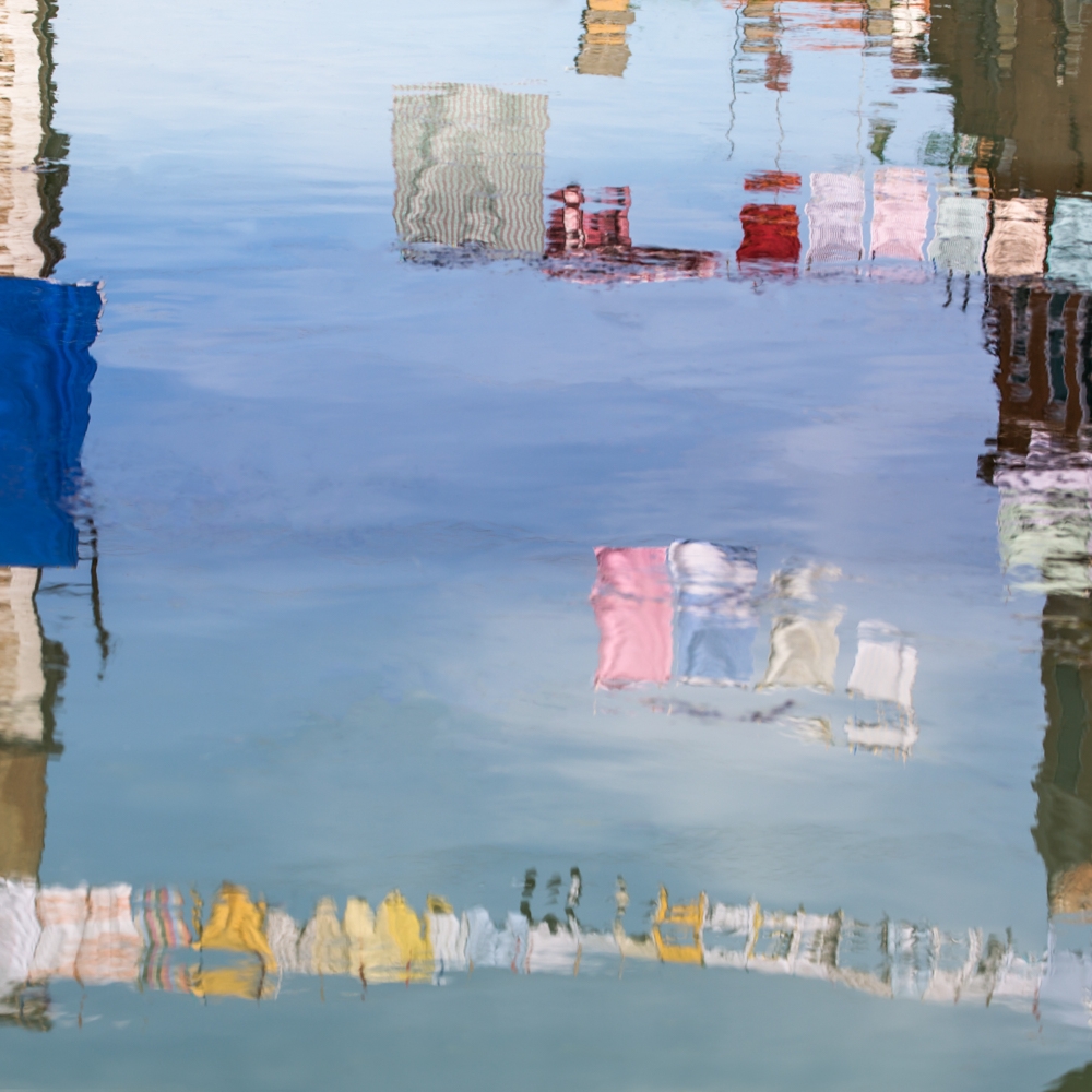 Clotheslines reflected in canal in Venice
