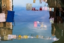 Clotheslines reflected in a Venetian canal