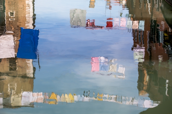 Clotheslines reflected in canal in Venice