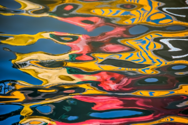 Colorful abstract reflections in canal in Venice, Italy