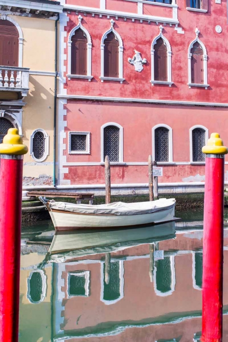 Reflections in Chioggia, white boat and pink building.